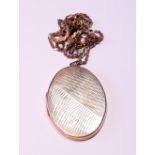 9ct gold oval locket, part engine turned, with necklet, 20g gross.