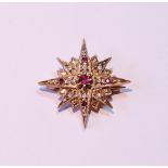 Small diamond and ruby star brooch in 9ct gold, 1966, 4g gross.