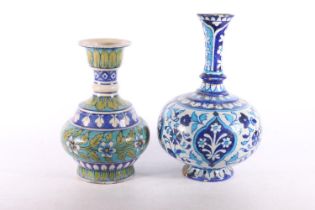 Two Persian Iznik style pottery vases, 28cm and 23cm high.  (a/f)  #219