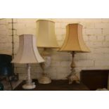 Three standard table lamps with shades.