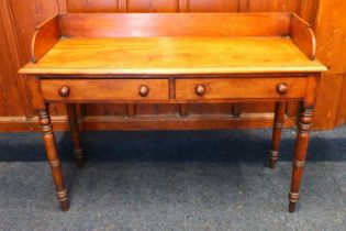 A William IV or early Victorian mahogany washstand having ledge back, two frieze drawers raised on