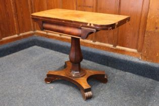 A William IV mahogany card table with fold-over top raised on a octagonal tapering baluster column