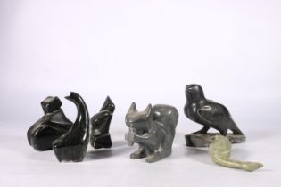 Six Canadian or Inuit soapstone carvings to include a reclining seal, a squirrel, a falcon, etc.  (