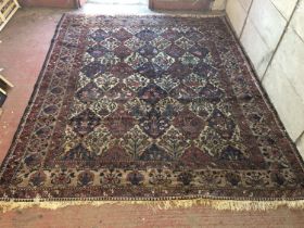 North west Persian carpet, field with decorated lozenge motif with floral borders, 400 x 350cm.