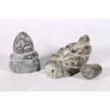 Three Canadian or Inuit soapstone carvings, one of a man on sled, 12cm long, and two others.  (