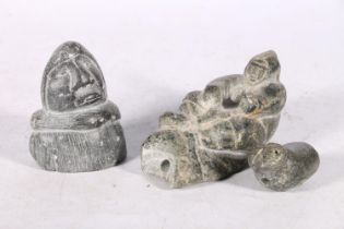 Three Canadian or Inuit soapstone carvings, one of a man on sled, 12cm long, and two others.  (