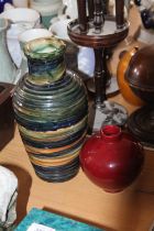 Studio pottery vase with ribbed exterior, 28cm, and another sang de boeuf vase.