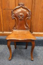 A Victorian mahogany hall chair with carved sheild back. #522
