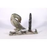 Three Canadian or Innuit soapstone carvings to include a hunter in sledge with two huskies, signed