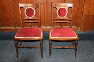 A pair of Sheraton style mahogany and inaid ladies hand chairs upholstered in dark red velvet. (