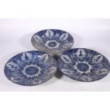 Three 18th century Delft pottery plates, matching cobalt blue and white design, each faulty, 31cm