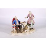 French porcelain figure group of Frederick II and Voltaire modelled seated with a greyhound, 23cm