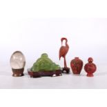 Oriental decorative items comprising a Peking glass Buddha on stand 12cm wide, a rock crystal egg on