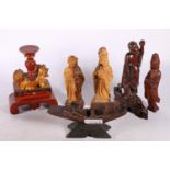 Carved wooden Fu dog on footed stand, painted red and gold, 11.5cm high, a carved wooden boat on