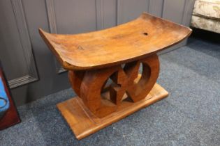 African hardwood stool in the form of a neck rest, 54cm long.