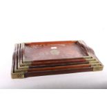 Five nested brass bound Chinese trays, the largest 53cm long. #306