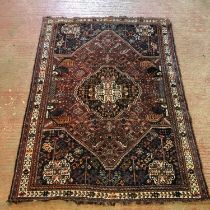 Caucasian rug with central medallion flanked by palm topped columns within foliate field and border,