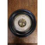 Circular bulk head barometer in ebonsied frame, 27cm diameter.