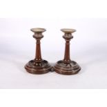 Pair of turned mahogany loaded candlesticks with brass drip trays, 21cm tall. #196