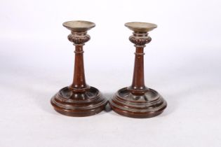 Pair of turned mahogany loaded candlesticks with brass drip trays, 21cm tall. #196