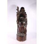 Carved wooden figure of a Chinese immortal Pu-tai, 57cm high.  #485