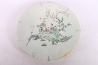 Chinese famille rose pottery plate decorated with figures in a landscape, red seal mark to reverse