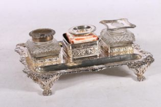 White metal desk stand, with three inkwell holders and double sided pen wells, raised on lion paw