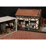 Diorama of The Copper Kettle and another of a garden scene, largest measures 104cm wide.