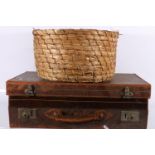 Vintage leather suitcase and a basket.