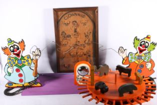 Vintage toys including a wooden animal circus toy, Fairground buzzer game and Clown-Up pinball game,