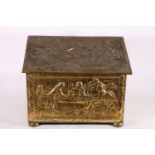 Brass embossed log box depicting a classical scene, 47cm wide.