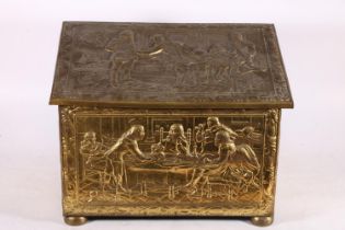 Brass embossed log box depicting a classical scene, 47cm wide.