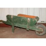 Green-painted wooden wheelbarrow, 160cm long.