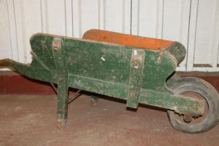 Green-painted wooden wheelbarrow, 160cm long.