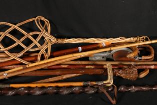 Silver-collared riding crop, a Malacca cane, a shooting stick, a carpet beater and walking sticks.