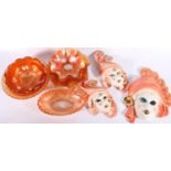 Eight pieces of Carnival glass and a set of three graduated ceramic wall masks.