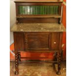 Early 20th century washstand with marble top and tiled back.
