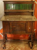 Early 20th century washstand with marble top and tiled back.