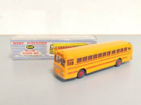 Dinky Toys. Boxed Wayne School Bus with Windows and Seating No. 949, yellow body with red interior.