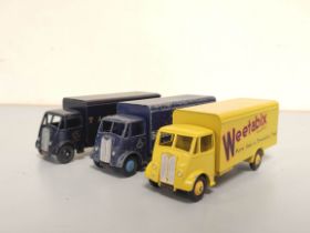 Dinky Toys. Three no 514 diecast goods vehicles comprising of "Lyons Swiss Rolls" in dark blue,