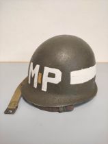 USA WW2 era M1 helmet with military police markings c1944. Original olive green textured painting