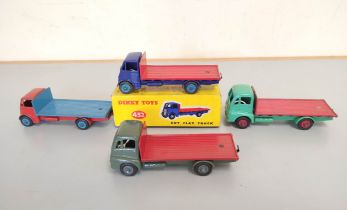 Dinky Toys. Boxed diecast Guy Flat Truck no 432 with blue cab & red bed. Also three others loose,