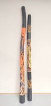 Two wooden didgeridoos, each painted with aboriginal motifs. (2)