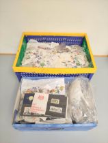 Two boxes containing a large quantity of mixed world postage stamps. (2)