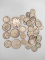 Silver world coins to include an 1883 U.S morgan dollar, a 1936 Southern Rhodesia shilling, and a