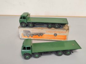 Dinky Toys. A boxed Foden Flat Truck no 502 with dark green cab and bed. Also another similar loose.