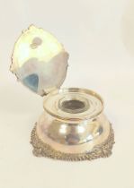 Silver inkwell with chased borders and hinged cover, inset cut glass well by Carrington & Co 1906.