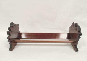 Victorian mahogany book trough with carved floral ends. 19 cm high, 50.5cm wide, 19.5cm deep.