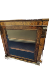 Victorian inlaid walnut pier cabinet with glazed door enclosing shelved interior on plinth