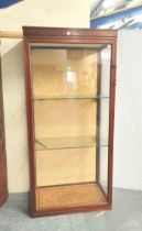 Vintage mahogany glazed shop cabinet with glazed door and panels enclosing metal brackets and